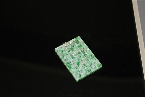 A carved jadeite and diamond set rectangular pendant, both sides decorated with Chinese characters and scrolls, 53mm,